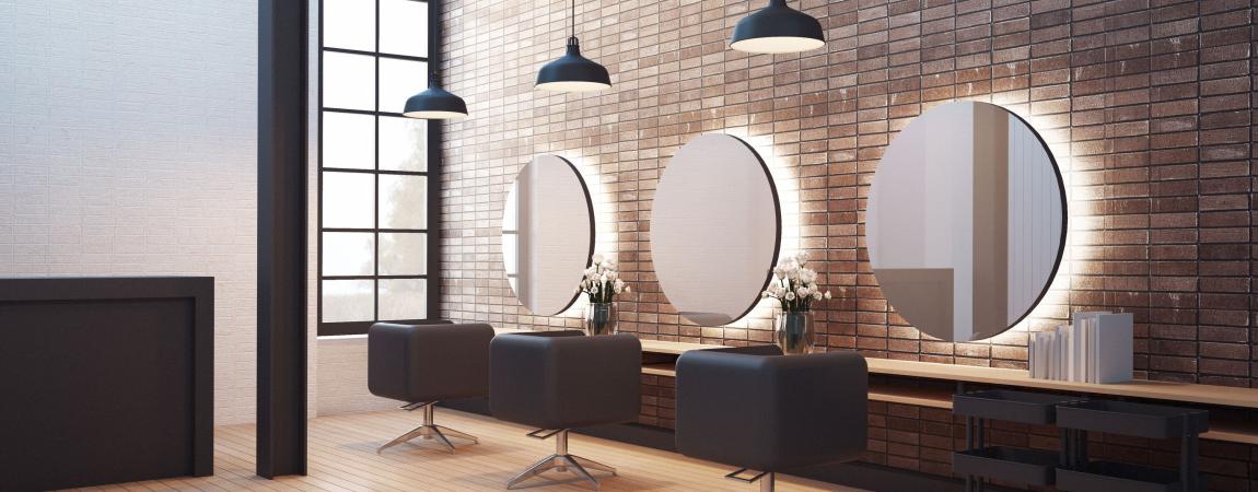 An upscale salon in side with chairs and mirrors